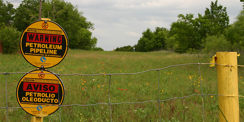 Picture of a Sign that Reads, Warning Petroleum Pipeline