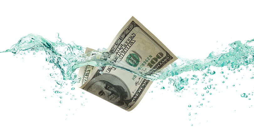 $100 Dollar Bill floating in water