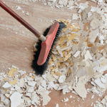 Broom sweeping up construction dust and debris