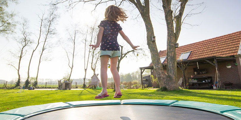 Little girl jumping on a trampoline