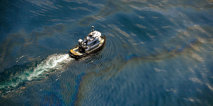 A boat traversing an oil spill in the Gulf of Mexico